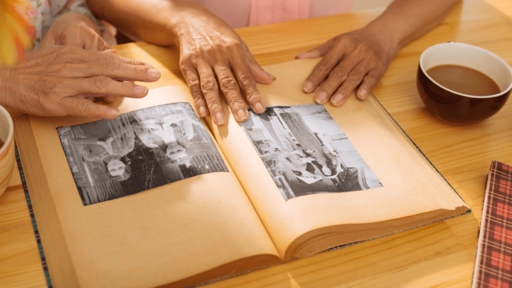 women looking through scrapbook of old photos
