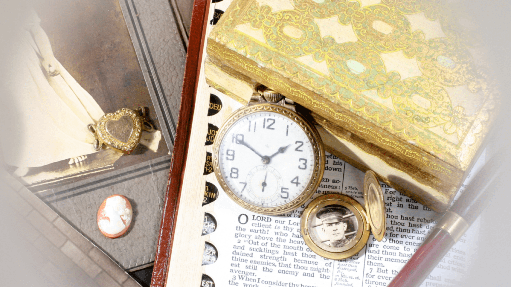 A group of family heirlooms including photos, jewelry, and books.