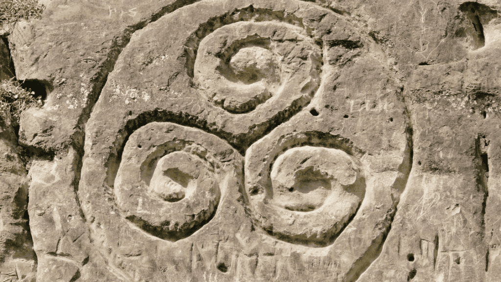A Triskele, a Celtic symbol for family, etched into a stone