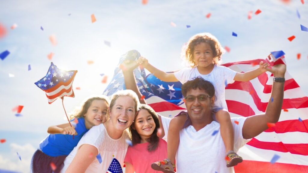 Family celebrating their cultural identity as Americans with American flags. 