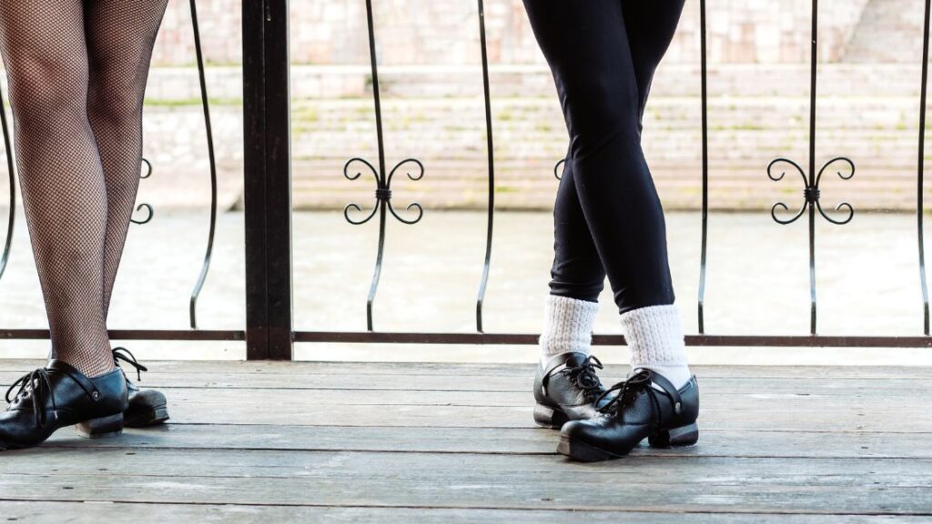 Legs and feet of Irish river dancers in traditional shoes and leggings. 