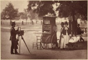 family in victorian era having their portrait taken outdoors