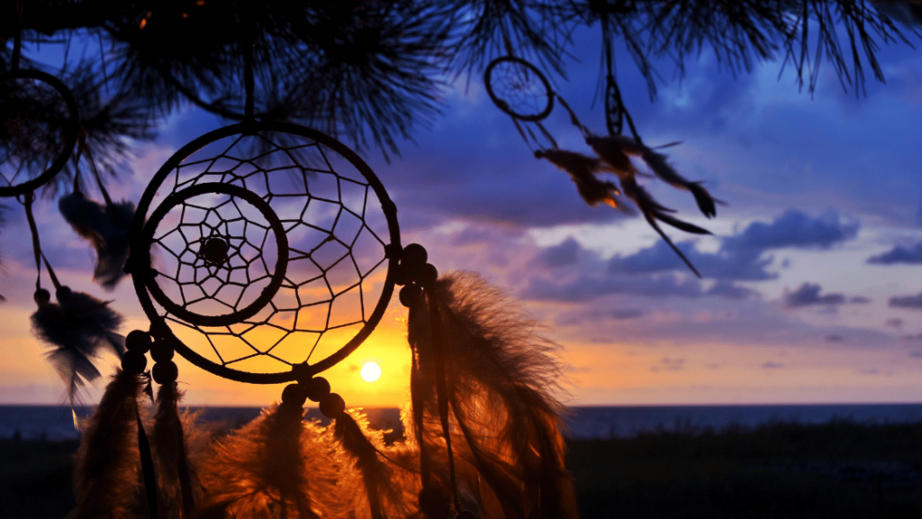 Traditional indigenous dreamcatcher with sunset in background.