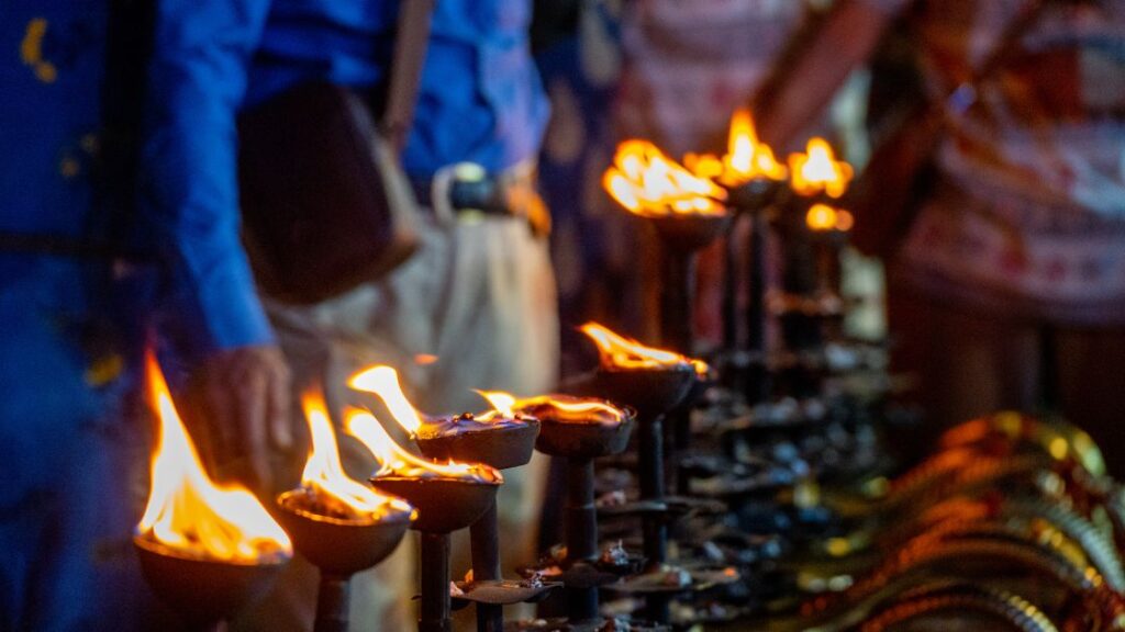 People gathered around a ritual fire.