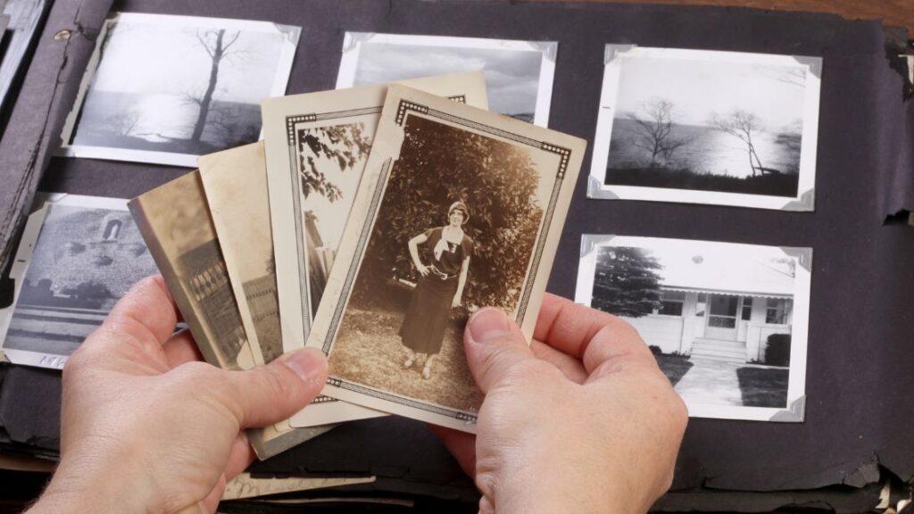 Hands holding vintage sepia photos