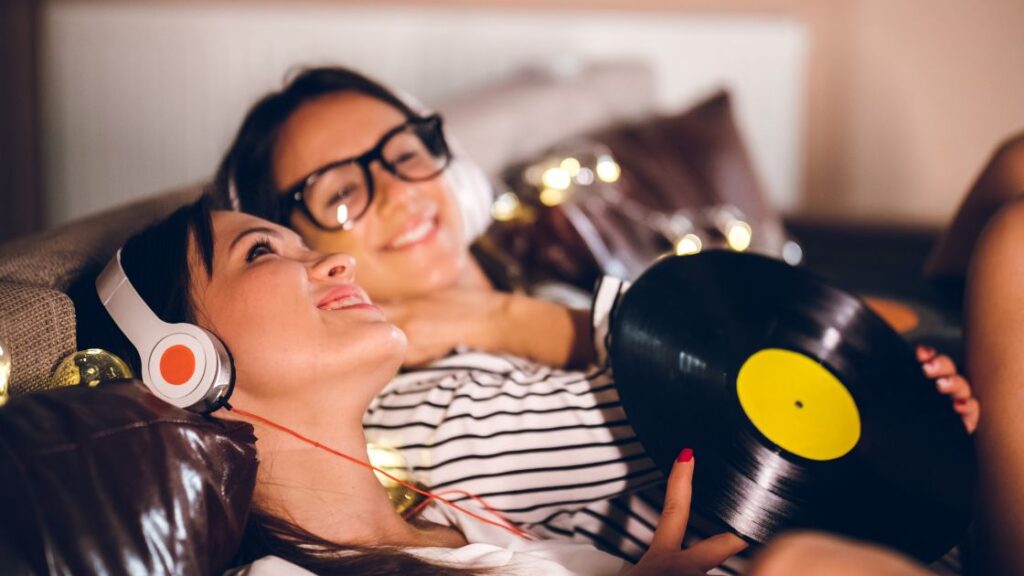 two women listening to vinyl records