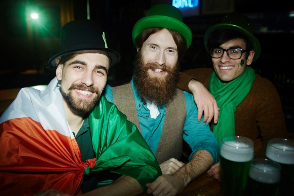 three men smiling as they celebrate St. Patrick's Day