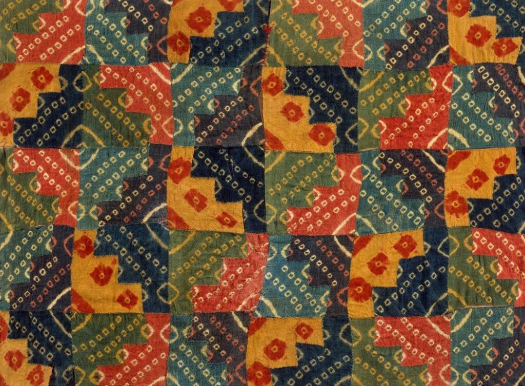 Colorful pattern on patchwork textile of Peruvian chakana or Andean cross