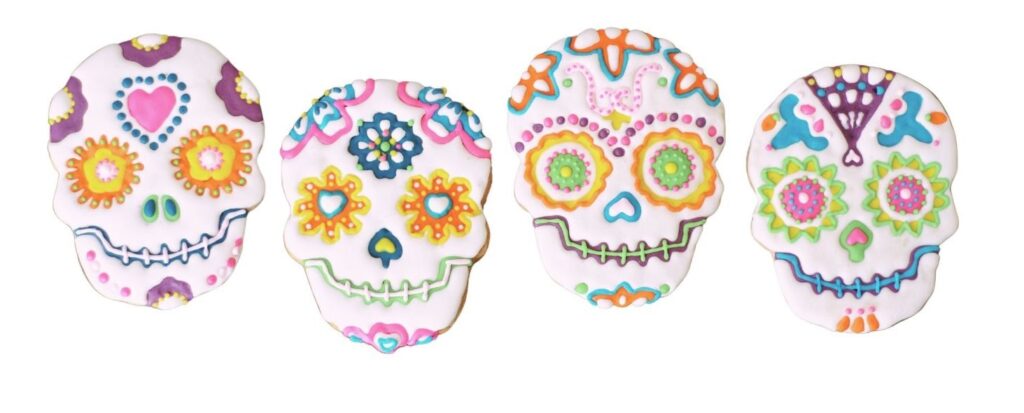 drawing of four day of the dead skulls decorated in bright colors