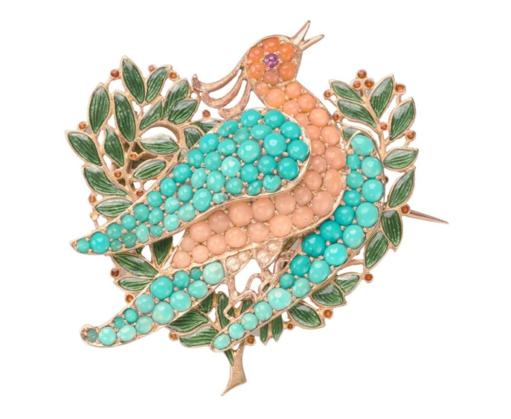 a jeweled brooch showing a dove carrying an olive branch