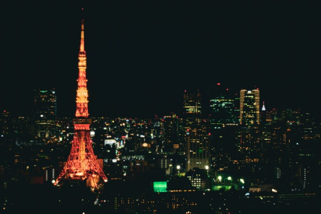 Tokyo Tower lit up against night sky.