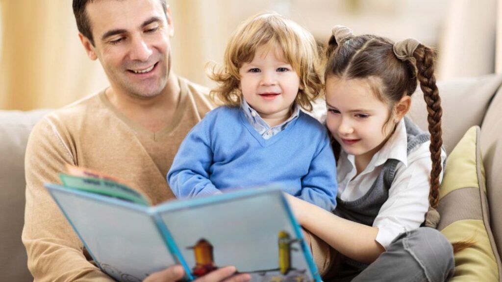 dad reading to two small children